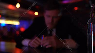 Drunk man lying on bar counter alone, frivolous lifestyle, alcoholism concept