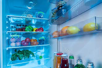 Open interior of a fridge packed with fresh food
