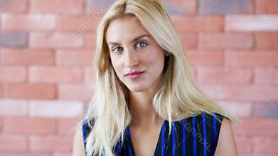 Beautiful lady near brick wall
