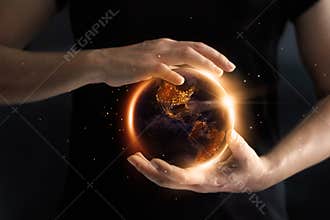 Hands holding global showing the world` s energy consumption.