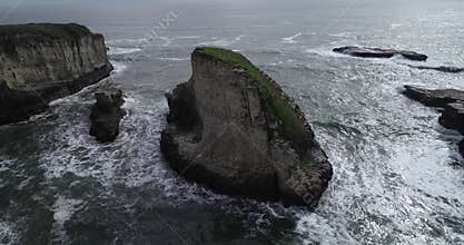 Shark Fin Cove Beach with a Towering rock and Sea Cave. California. Pacific  Ocean Waves. Island. Drone 1
