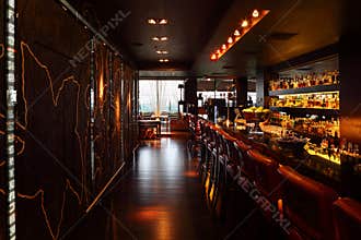 Bar counter with tall chairs in empty restaurant