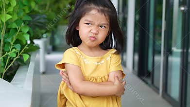 Portrait of funny Asian angry and sad little girl, The emotion of a child when tantrum and mad, expression grumpy emotion. Kid