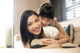 Asian daughter hugs mother