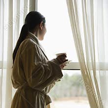 Woman looking out window.