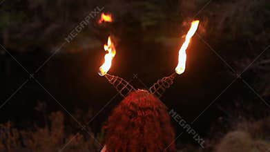 Woman dancing fire spin with smoke and flame