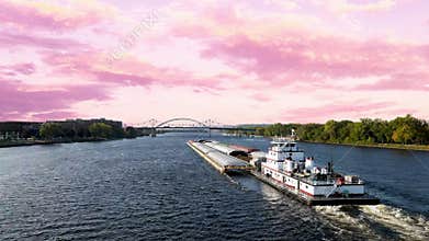 Landscape of boat in Mississippi River under a pink cloudy sky in La Crosse, Wisconsin