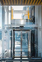 Modern Elevator and Interior Architecture of Building Facility, Entrance Door and Stainless Steel Frame of Transparency Elevator.