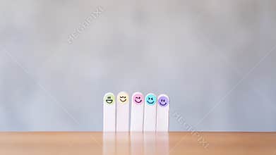 Colorful hand draw happy emotion faces on wooden stick