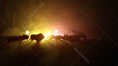 A group of animals are grouped together at foggy night with burning colorful background. Animals Running Escaping to Save Their Li