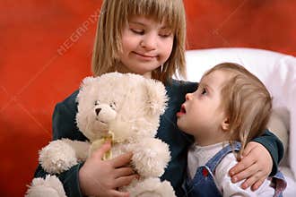Two toddlers holding each other