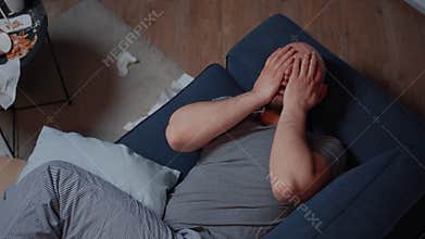 Traumatized adult man finding news that makes to fall into desperation