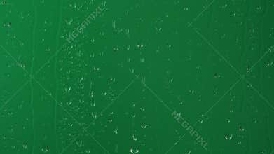 Water rainfall, rain drops falling on window glass over chroma key green screen