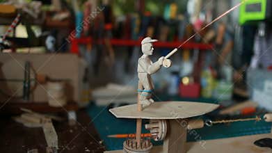 Doll master turns the handle of the automaton