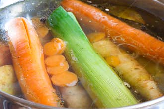 Boiling broth in pot, background