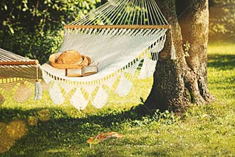 View of hammock and book on a summer day