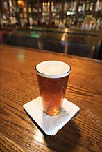 Pint of beer on bar.
