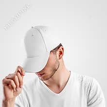 Mockup of a white baseball cap on a guy, straightening visor, side view, textile hat for presentation of design, pattern