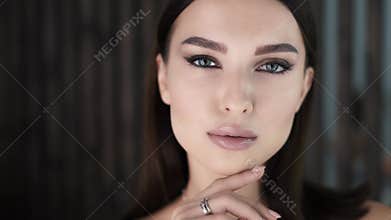 Portrait of a beautiful charming woman with professional bright makeup