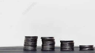 Coins diminishing on stack on white background