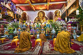 Monks are chanting prayers of repentance in main hall of Vinh Nghiem pagoda