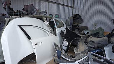 Closeup of wrecked car doors stacked at body shop mechanic. Stack of doors on sale for spare parts. Trade in used auto