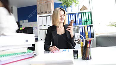 Beautiful businesswoman working with laptop and documents in office