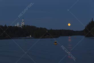 Yellow moon over the bay near Valaam Monastery