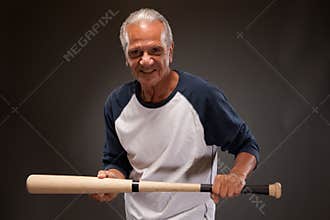 Portrait of a senior man posing with a baseball bat