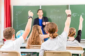 Teacher educate or teaching a class of pupils in school