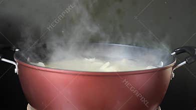 Boiling cassava in hot pot on stove
