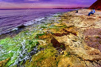 Sunset on rocky coastline