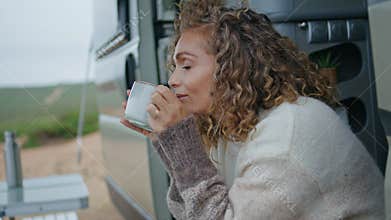 Relaxed traveller drinking coffee sitting trailer stairs close up. Happy woman