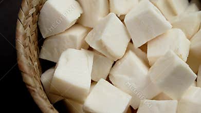 Yuca Cassava root raw slices in rustic bowl.