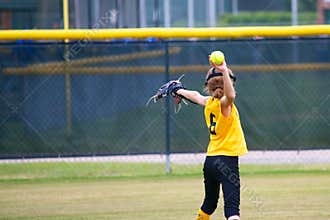 Girl Throwing a Softball