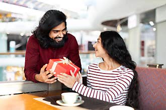 Happy romantic young eastern couple celebrating special occasion together