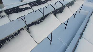 Rows of solar batteries covered by snow at winter