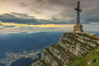 Beautiful sunrise in the mountains and Caraiman Heroes Cross Monument in Bucegi mountains,Carpathians,Romania