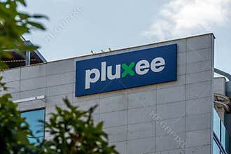 Sign and logo on the headquarters of Pluxee International, Issy-les-Moulineaux, France