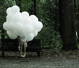 Sentimentality. Nostalgia. Lonely Woman with Air Balloons sitting on Bench in the Park