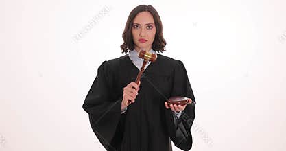 Serious brunette woman judge bangs gavel pronouncing verdict