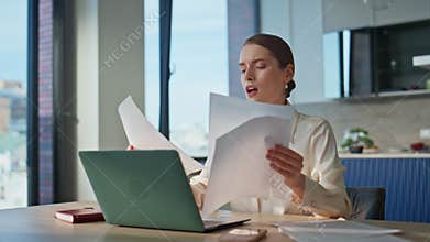 Serious woman reading documents worried business financial results closeup.