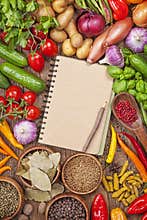 Fresh vegetables and blank recipe book