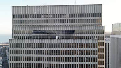 Facade of a modern office building with a repetitive pattern of windows and architectural details, urban corporate background