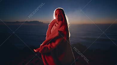 Fashion model posing sundown beach in fur coat zoom on. Woman modeling in dance