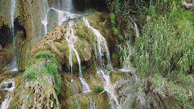 Drone footage captures waterfall travel destination in Turkeys mountains amidst greenery. Showcases waterfall travel