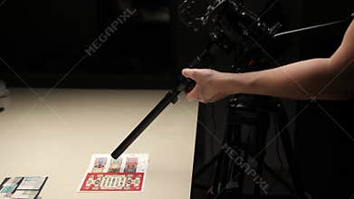 The videographer's hand adjusts the macro lens