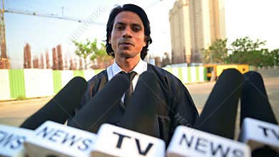 Attorney at law giving interview with multiple microphones