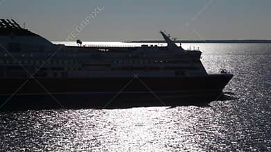in evening in dark on water by floats big cargo