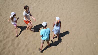 Woman with three children play blindman buff on
